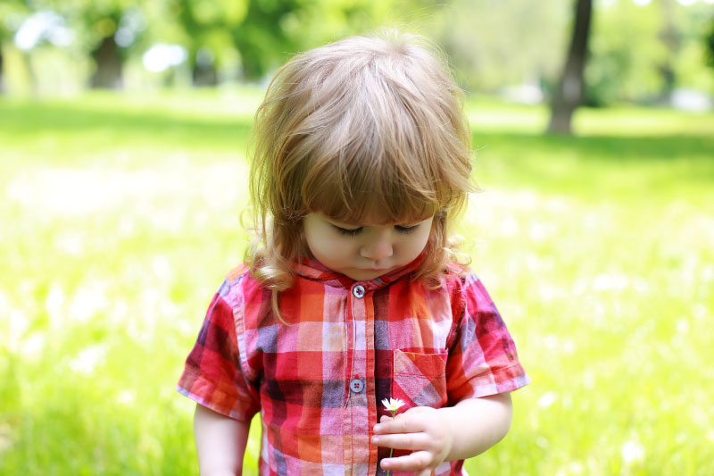 LIttle girl in park playing as part of infant mental health